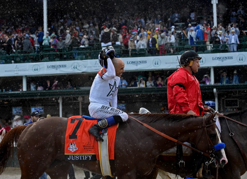 Jockey Mike Smith smiles after riding Justify to win the 144th running of the Kentucky Derby, the wettest in history, Saturday, May 5, 2018, at Churchill Downs in Louisville, Ky. Longines, the Swiss watch manufacturer known for its luxury timepieces, is the Official Watch and Timekeeper of the 144th annual Kentucky Derby. (Photo by Diane Bondareff/Invision for Longines/AP Images)
