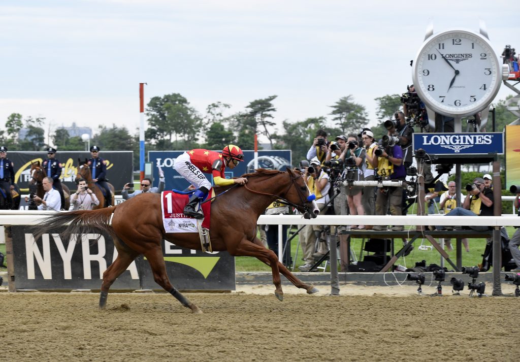 Justify, ridden by Mike Smith, wins the Triple Crown and the 150th running of the Belmont Stakes, Saturday, June 9, 2018, at Belmont Park in Elmont, NY. Longines, the Swiss watchmaker known for its elegant timepieces, is the Official Timekeeper and Watch of the 150th running of the Belmont Stakes. (Photo by Diane Bondareff/AP Images for Longines)