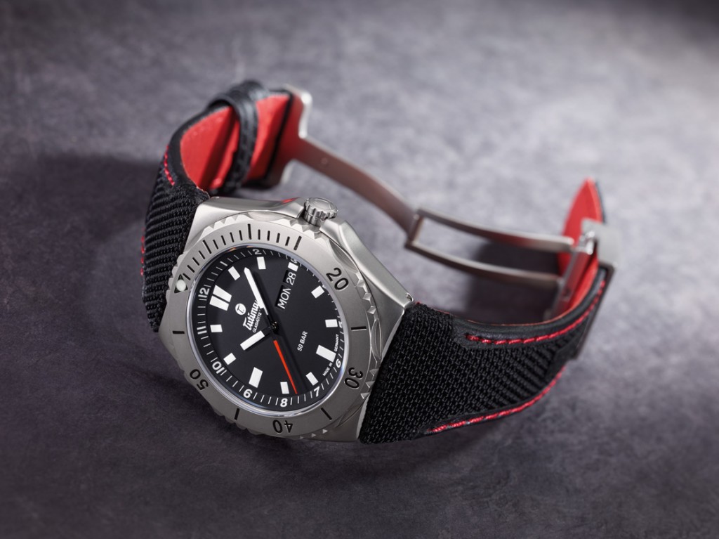 The black-dialed Seven Seas features a black Kevlar strap with red stitching and red inner lining 
