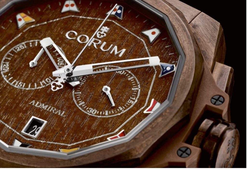 The dial of the Corum AC-One Bronze Chronograph is crafted of real teak wood and features nautical pennants as markers. 