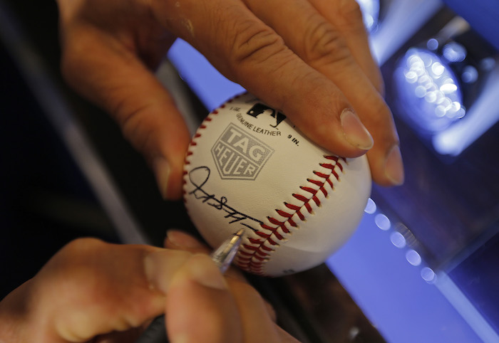 Stanton autographed baseballs at the TAG Heuer event for a host of guests .