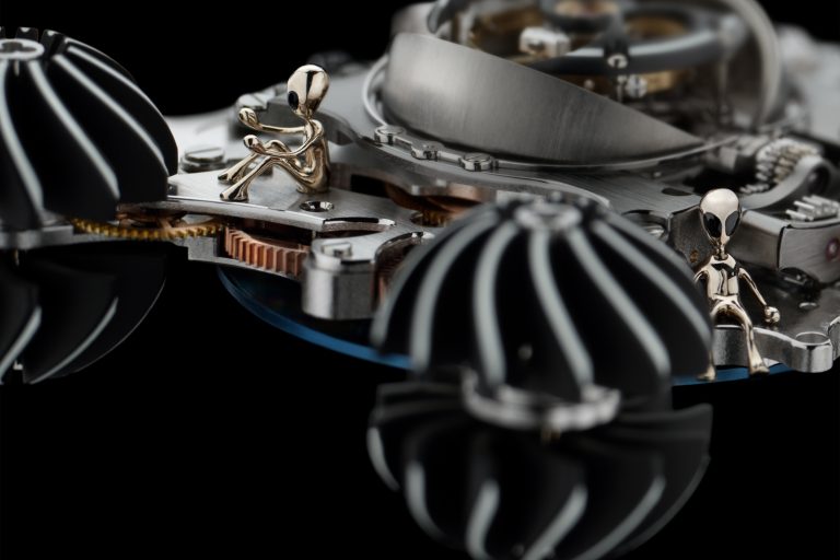 In addition to the pilot alien that sits in the MB&F HM6 Alien Nation case between two of the turbines, there are five more alien crew members inside the watch.