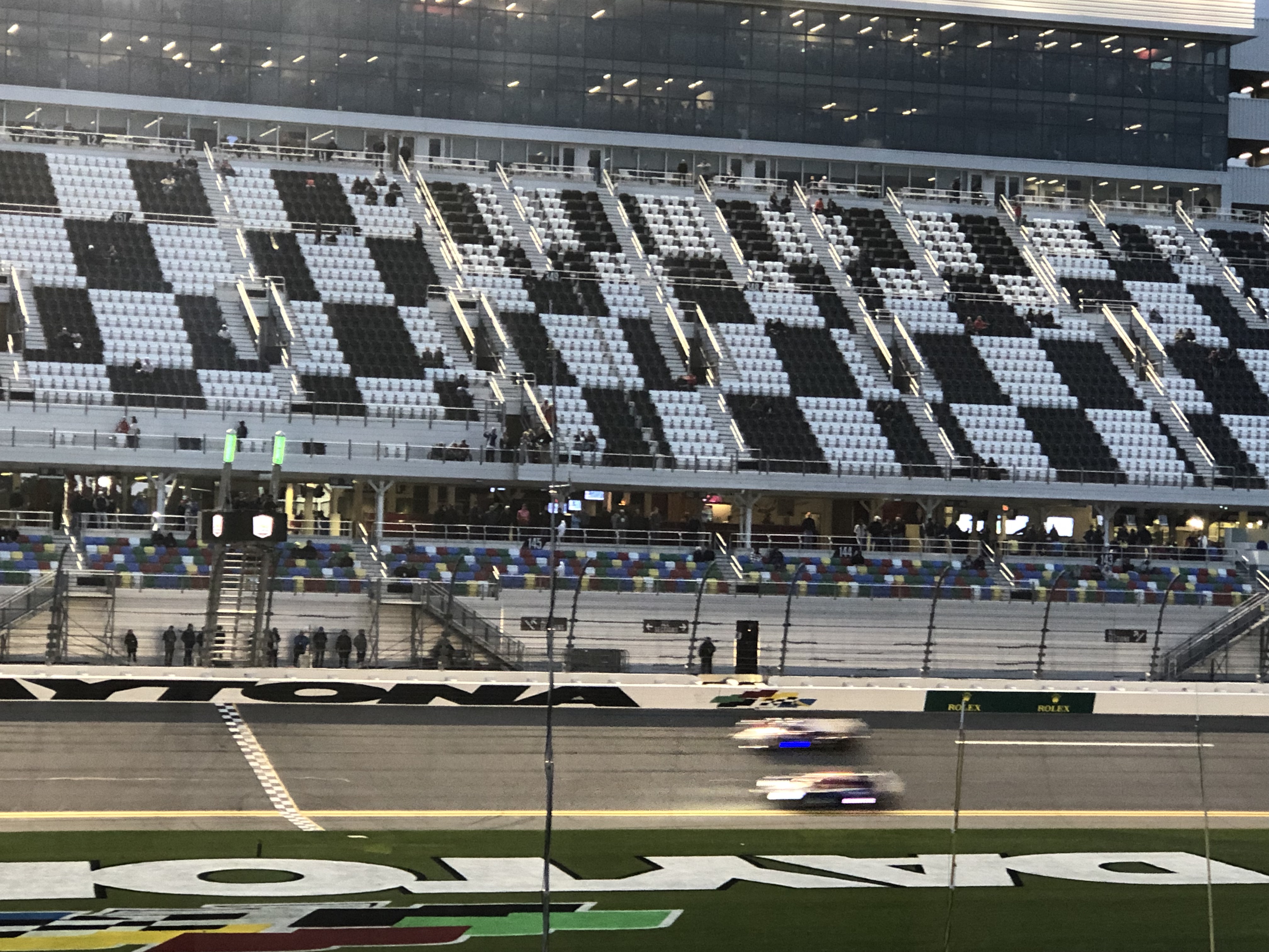 Racing under the lights at night at the Rolex 24 At Daytona. 