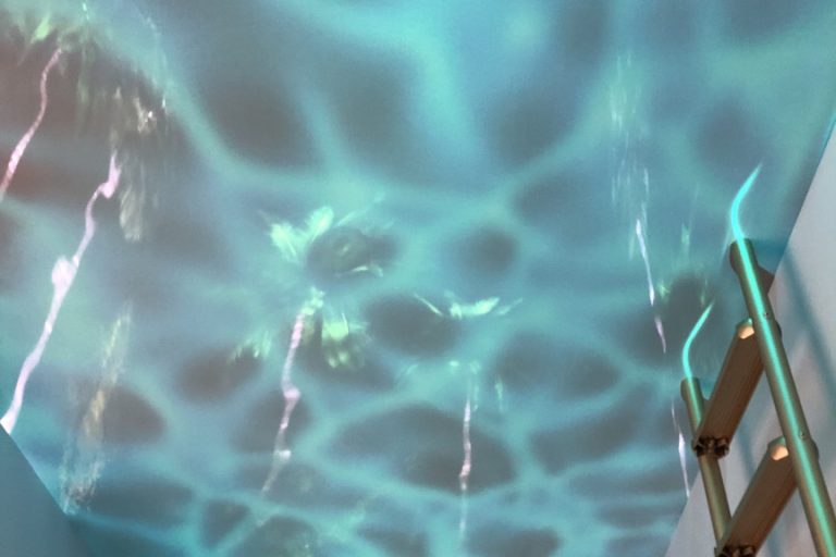 A back room at the Piaget exhibition space at SIHH 2018 makes you feel as though you are underwater in a swimming pool.