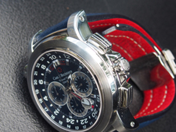 The blue dial and strap is accented with a red GMT hand and a red lining on the leather strap.