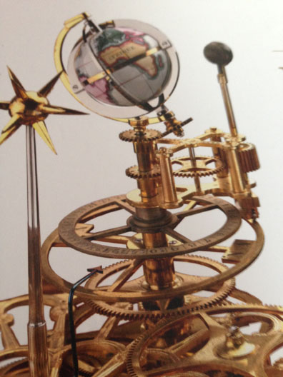 A close up of a planetary clock.