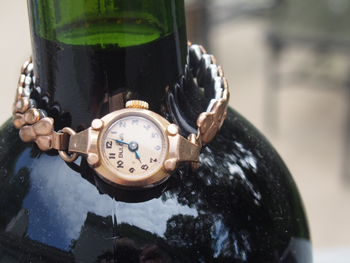 A mechanical 1940's Bulova (shown on the neck of a wine bottle to demonstrate its petite  size)